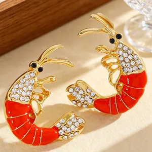 Detailed close-up of red enamel lobster earrings with sparkling rhinestones for ocean style