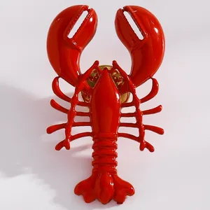 Close-up macro view of a vibrant red glossy alloy lobster earring detail for women