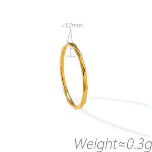 Close-up detail of a minimalist gold faceted water ripple titanium steel ring weight 0.3g