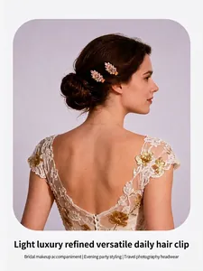 Close-up of elegant leaf-shaped gold hair clips with crystals on a bridal bun