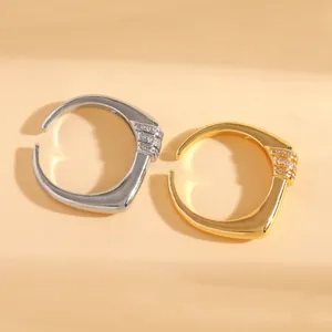 Detailed view showing the elegant gold and silver open rings with sparkling micro-paved zircon stones