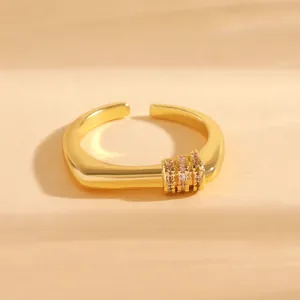 Detailed close-up showing the micro-pave zircon settings on a gold-plated open ring