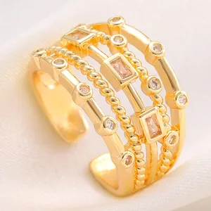 Close-up detail of multi-layered gold adjustable ring set with clear zircon stones