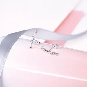 Close-up of S925 silver curved bar stud earrings with sparkling cz stones