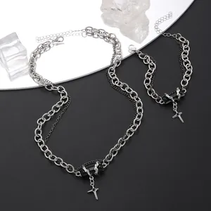 Detailed view of punk street style cross necklace and bracelet set with black stone