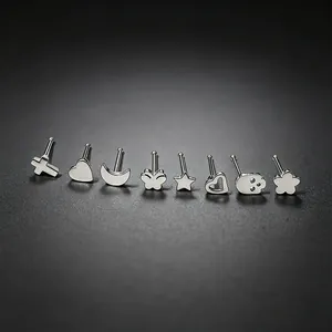 Detailed view of silver stainless steel nose studs in various shapes like heart and star
