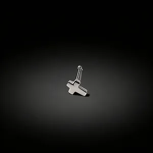 Macro view of a polished silver cross nose stud with straight bar on dark gradient