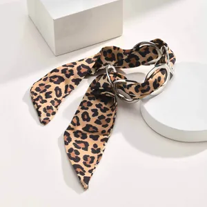 Detail view of silver stainless steel geometric ring bracelet with leopard print scarf