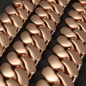 Macro detail shot of a polished rose gold Cuban link chain for men's hip-hop style.
