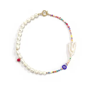 Bohemian Evil Eye necklace featuring colorful seed beads and baroque pearls on white backdrop