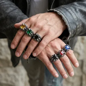 Close-up of men's eagle claw rings with multi-color square gemstones on model's hands
