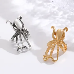 Detailed view of gold and silver octopus-shaped alloy ear clips with textured tentacles