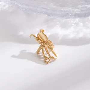 Macro detail of a vintage gold-toned octopus-shaped ear cuff with intricate textured finish