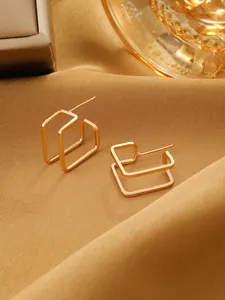 Close-up detail view of elegant double rectangular hollow geometric earrings in shiny gold finish