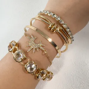 Detailed view of vintage punk gold layered bracelet set with clear faux gemstones