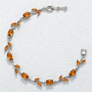 Detail view of silver bracelet featuring orange marquise and oval leaf-shaped stones.