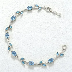Detailed view of the elegant blue crystal leaf and petal design on a silver-toned bracelet
