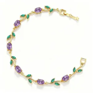 Detailed macro shot of elegant gold vine bracelet with purple and green floral crystals.