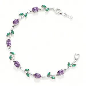 Detailed view of elegant copper bracelet with amethyst-colored tulip and emerald leaves.