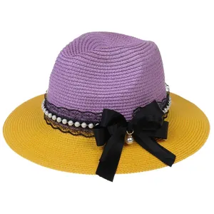 Two-tone purple and yellow wide-brimmed straw hat with elegant lace and pearl bow