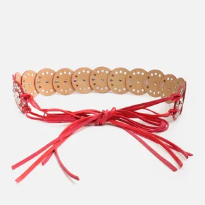 Detailed view of a red ethnic style wide waist belt with laser-cut hollow out patterns