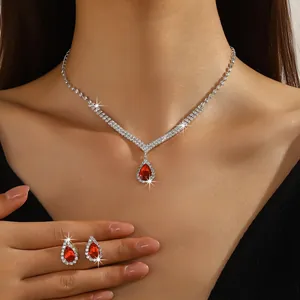 Detail view of elegant red teardrop zircon necklace and earrings set for weddings