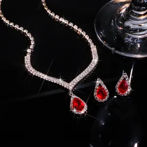 Close-up of sparkling teardrop red zircon necklace and earrings bridal jewelry set