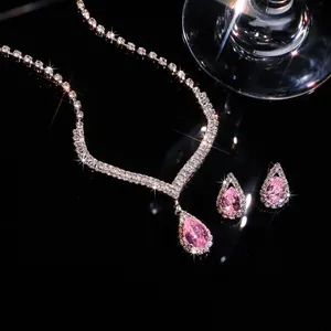 Detailed macro view of sparkling pink teardrop zircon necklace and earrings wedding set