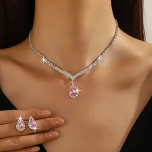 Detailed view of sparkling pink teardrop zircon necklace and earrings jewelry set for weddings