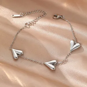 Simple silver titanium steel bracelet with three heart charms on champagne satin