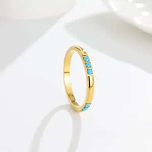 Detailed view of elegant gold titanium steel ring with inlaid blue turquoise stones