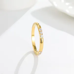 Detail view of gold-plated titanium steel ring with three clear cubic zirconia inlays
