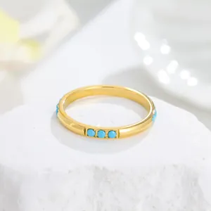 Exquisite close-up detail of a gold plated titanium steel ring with turquoise inlays