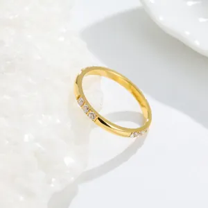 Close-up detail of a gold-plated titanium steel ring with sparkling clear pavé stones.