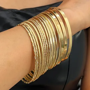 Close-up of vintage gold bangle set featuring smooth and textured finishes on arm