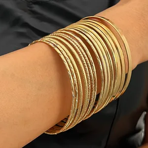 Stackable gold-tone alloy bangle set with various textured finishes for stylish women
