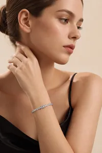 Detail shot of a sparkling S925 silver tennis bracelet worn on a woman's wrist