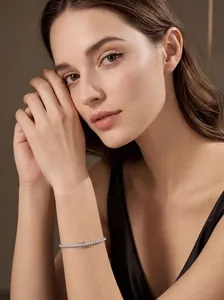 Detailed view of a sparkling sterling silver moissanite tennis bracelet on a wrist