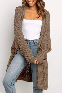 Vista detallada de una cómoda chaqueta de punto marrón oversize con bolsillos grandes