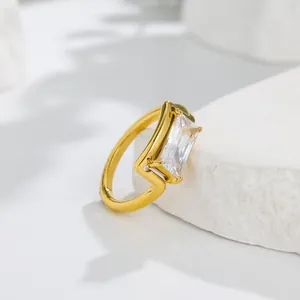Close-up of a minimalist 18k gold plated ring featuring a sparkling rectangular sugar cube zircon
