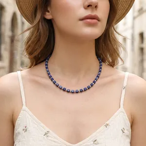 Close-up detail view of elegant lapis lazuli square bead choker necklace on model's neck