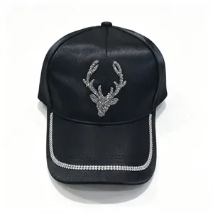 Black satin baseball cap with rhinestone reindeer head and crystal brim detail