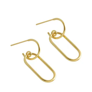 Detailed shot of minimalist gold-plated geometric oval link earrings on white background