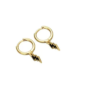 Detailed view of gold plated hoop earrings with black enamel lightning bolt charms
