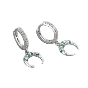 Elegant silver hoop earrings featuring crescent moon charms with green stones detail
