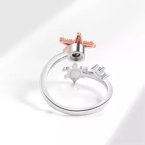 Verstellbarer silberner Anti-Angst-Ring mit Roségold-Seestern und Schildkröte