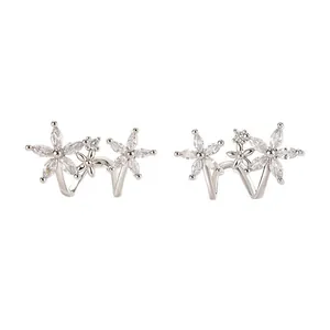 Detailed macro view of silver flower earrings with marquise-cut sparkling zircons.