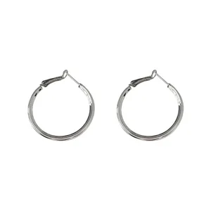 Detailed view of minimalist silver hoop earrings showing smooth polished metallic finish