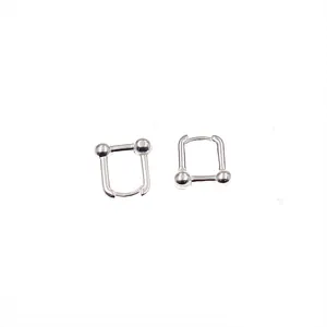 Detailed macro view of minimalist silver U-shaped link earrings with double ball ends