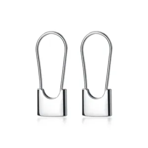 Close-up of minimalist silver padlock-shaped geometric earrings with smooth finish